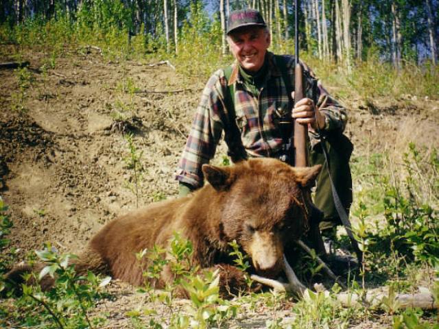 Another happy Swede with a 350 lb. brown-black bear. Thinking the wind was wrong, the strategy was to move Bo to another location. When his guide, Heather, went over to him she found two dead bears. Both were taken on an abandoned oil lease within a 2 hour period. Bo\'s hunting partner, Kent, later wounded a grey wolf that was after the bear carcasses. He had missed another grey 3 days earlier.