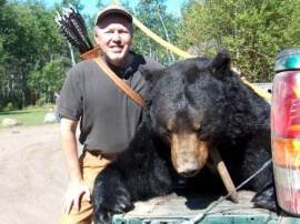 Recurve archery hunter, Gordon, shows off his huge non-baited trophy bear. For his own enjoyment he makes his own recurve bows. Precision in archery making, his bows are among the best I have ever seen. What a huge bear measuring 8 feet.