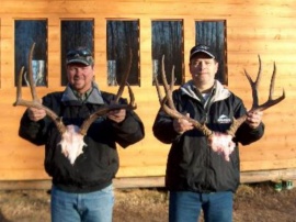 Guy and Dave hold up their bucks for display in front our camp kitchen. A good back ground that shows a hint of our hunting camp indicationg the care we have for our clients and their trophies. Two happy hunters with two quality trophies for their show rooms. Wishing you the best on all your future hunts.